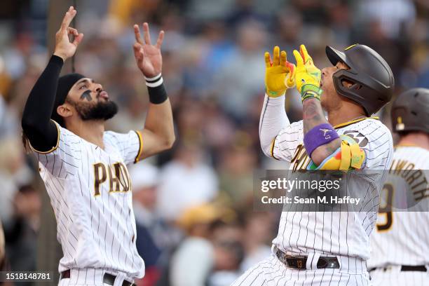 Fernando Tatis Jr. #23 congratulates Manny Machado of the San Diego Padres after his solo homerun during the sixth inning of a game against the Los...