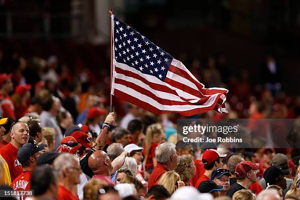 Fan flies an American flag during the seventh inning stretch as 9/11 is observed during the game between the Pittsburgh Pirates and Cincinnati Reds...