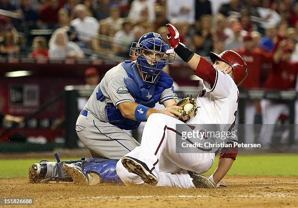 Catcher A.J. Ellis of the Los Angeles Dodgers tags out Miguel Montero of the Arizona Diamondbacks as he attempts to score a run during the seventh...