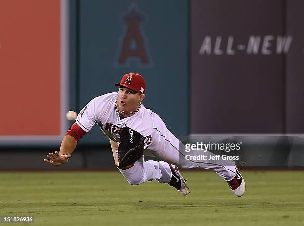 Center fielder Mike Trout of the Los Angeles Angels of Anaheim makes a diving catch on a ball hit by Yoenis Cespedes of the Oakland Athletics in the...