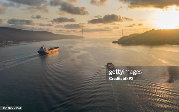 aerial view tanker ship with liquid bulk cargo and cargo ship in transit at sunrise. - cisterna imagens e fotografias de stock