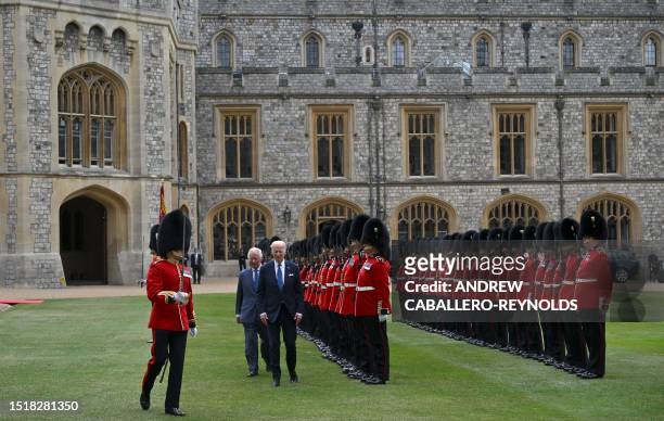 President Joe Biden and Britain's King Charles III inspect a guard of honour, formed by members of the Welsh Guards, during a ceremonial welcome in...