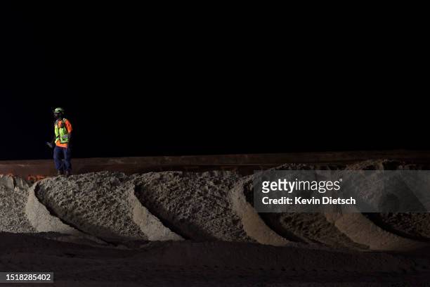 Contractor with the Army Corp of Engineers monitors bulldozers move sand as part of their beach and dune replenishment project on July 05, 2023 in...