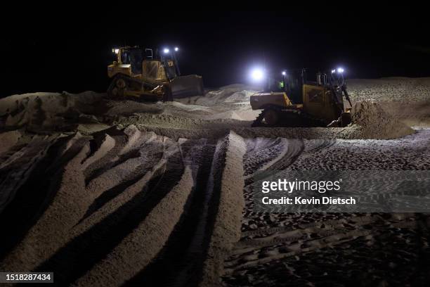 Contractors with the Army Corp of Engineers move sand as part of their beach and dune replenishment project on July 05, 2023 in Bethany Beach,...