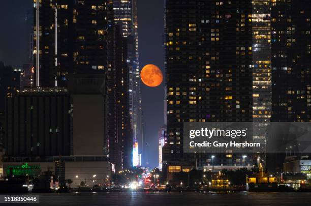 Percent illuminated waning gibbous moon rises over 42nd Street in New York City on July 5 as seen from Weehawken, New Jersey.