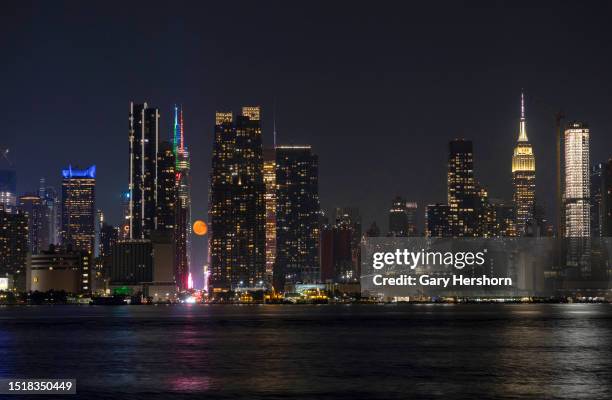 Percent illuminated waning gibbous moon rises over 42nd Street in New York City on July 5 as seen from Weehawken, New Jersey.