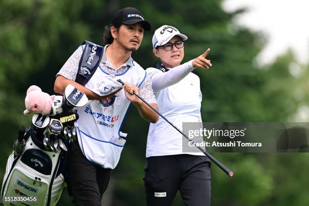 Sakura Yokomine of Japan talks with her caddie and husband Yotaro Morikawa on the 3rd hole during the first round of MinebeaMitsumi Ladies Hokkaido...