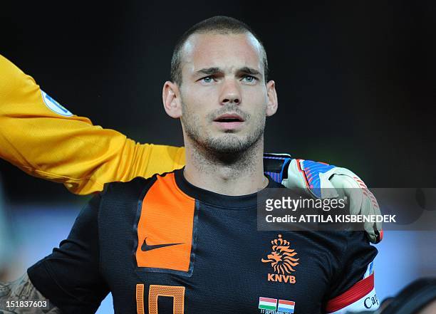 Netherland's captain Wesley Sneijder sings the national anthem on September 11, 2012 at Puskas stadium in Budapest before a World Cup 2014 qualifying...