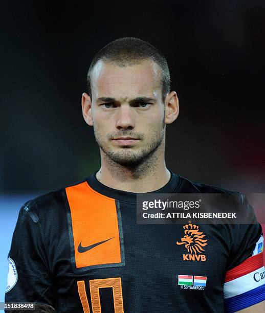 Netherland's captain Wesley Sneijder listens to a national anthem on September 11, 2012 at Puskas stadium in Budapest before a World Cup 2014...