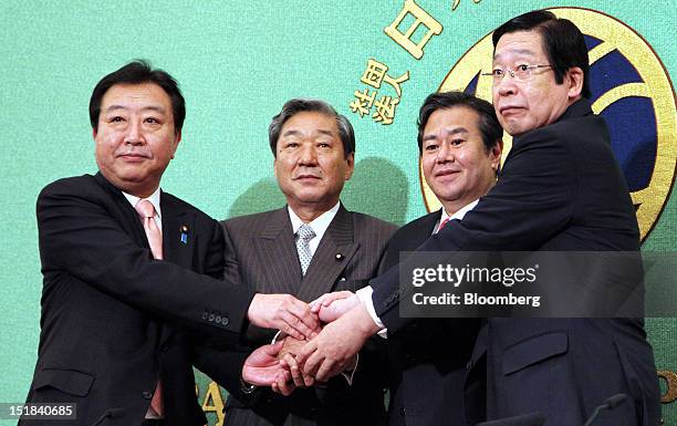 Candidates for leader of the Democratic Party of Japan shake hands during a debate at the Japan National Press Club in Tokyo, Japan, on Thursday,...