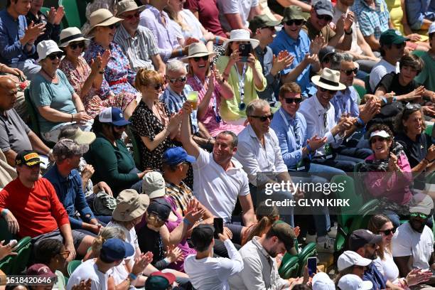 Spectator catches the ball in his Pimm's glass during the men's singles tennis match between Czech Repbulic's Jiri Vesely and Russia's Daniil...