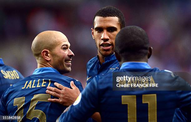 French defender Christophe Jallet and French midfielder Etienne Capoue jubilate next to French midfielder Rio Mavuba during the World Cup 2014...