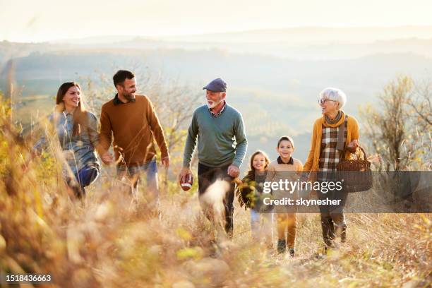 happy multi-generation family going on a picnic in autumn day. - kids picnic stock pictures, royalty-free photos & images