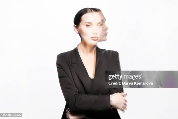 a businesswoman on a dark background, shot with a multi-exposure on a long shutter speed. the concept of fatigue, planning, multitasking. - on location for oblivion stock pictures, royalty-free photos & images