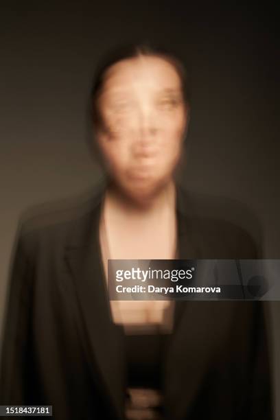 business woman in black suit on dark background with copy space. the dizzy concept, multi-tasking, headache and tiredness from hard intellectual work. - multi tasking photos et images de collection