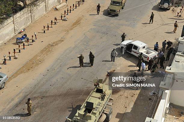 Somalia policemen gather at the area of a bomb blast at the Jazeera hotel compound on September 12, 2012 where the newly elected Somali president...