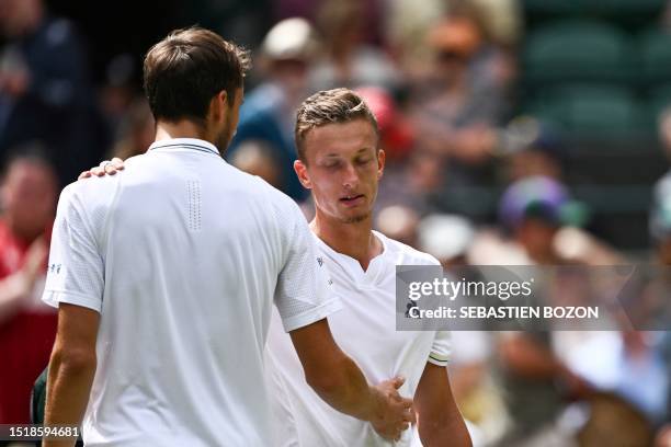 Russia's Daniil Medvedev comforts Czech Repbulic's Jiri Vesely as he retires from their men's singles tennis match on the eighth day of the 2023...