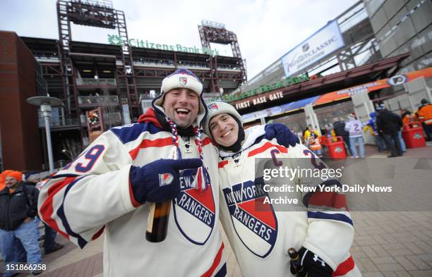 Shortly before they were pummeled by a group of thuggish Philadelphia Flyers fans, two die-hard Rangers fans happily mugged for a Daily News...