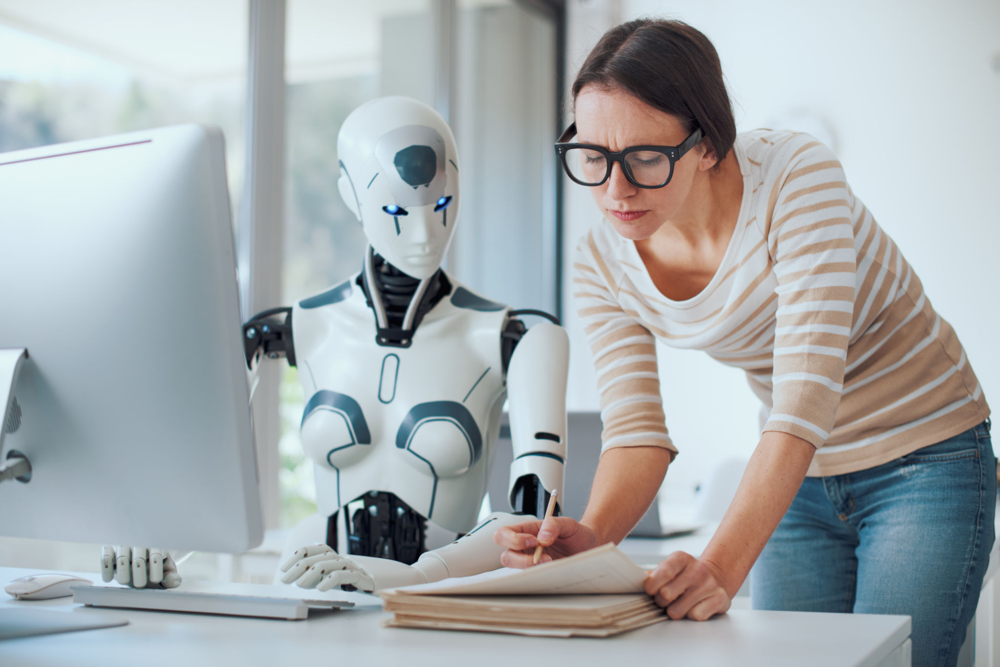Woman and AI robot working together Woman and AI robot working together