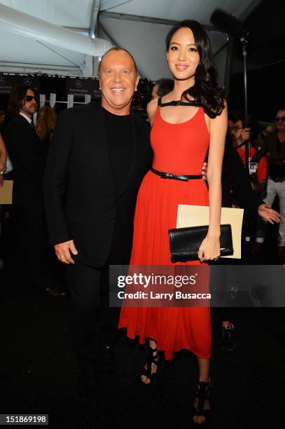 Designer Michael Kors and model Zhang Zilin pose backstage at the Michael Kors Spring 2013 fashion show during Mercedes-Benz Fashion Week at The...