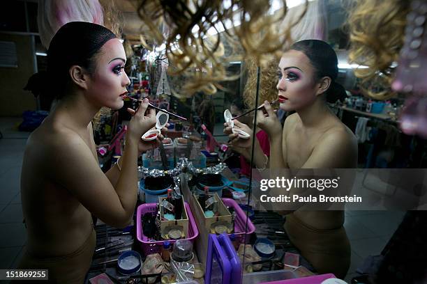 Pom, a ladyboy dancer at the Chiang Mai Cabaret show puts on her makeup backstage as up to 20 dancers get dressed before a performance September 9,...