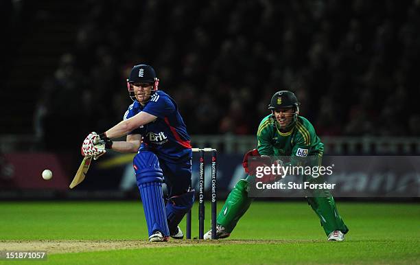 England batsman Eoin Morgan prepares to reverse sweep watched by South Africa wicketkeeper AB de Villiers during the 3rd NatWest International T20...