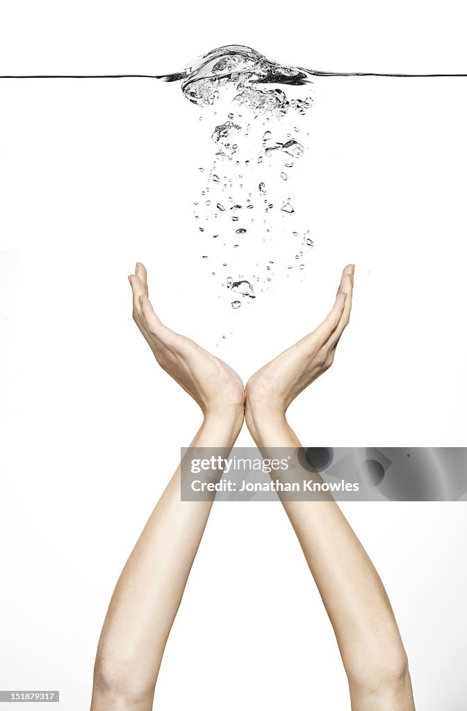 Female hands supporting floating bubbles
