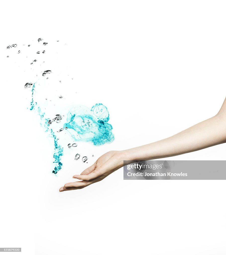 Female hand with colour liquid and bubbles