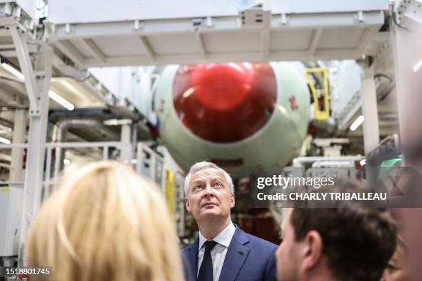 France's Minister for the Economy and Finances Bruno Le Maire looks up next to an under construction Airbus A321 body as he attends the inauguration...