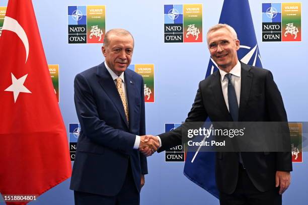 Turkish President Recep Tayyip Erdogan shakes hands with the Secretary General of NATO Jens Stoltenberg during their meeting ahead of the NATO...