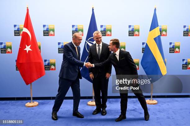 Turkish President Recep Tayyip Erdogan shakes hands with Swedish Prime Minister Ulf Kristersson as the Secretary General of NATO Jens Stoltenberg...