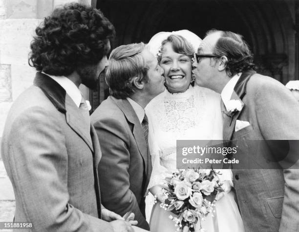 Gail Morecambe recieves a kiss from her father, comedian Eric Morecambe and his showbusiness partner Ernie Wise at her wedding at St Nicholas Church,...