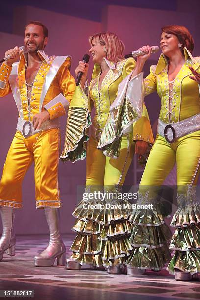 Guest performer Penny Smith performs with cast members Gary Milner and Sally Ann Triplett during the curtain call at the Mamma Mia! Gala Performance...