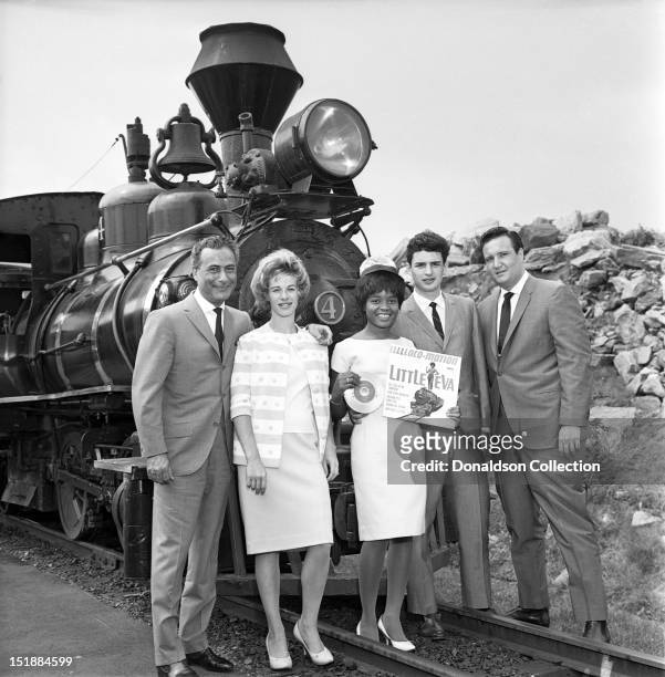 Little Eva poses for a portrait with L-R producer Al Nevins songwriter Carole King, Little Eva, songwriter Gerry Goffin and producer Don Kirshner on...