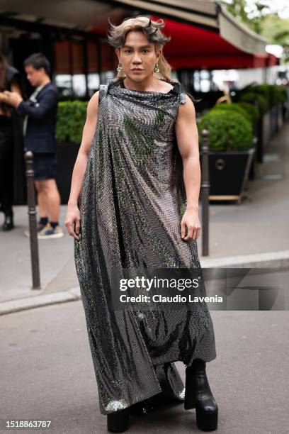 Guest wears a silver sequins maxi dress and black platform boots, outside Balenciaga, during the Haute Couture Fall/Winter 2023/2024 as part of Paris...