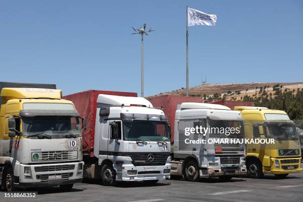 Convoy of trucks carrying humanitarian aid is seen parked after crossing the Syrian Bab al-Hawa border crossing with Turkey, on July 10, 2023....