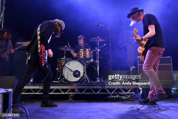 Aaron Lee Tasjan, Fredrik Aspelin and Petter Ericson Stakee of the band Alberta Cross performs on stage during Reading Festival 2012 at Richfield...