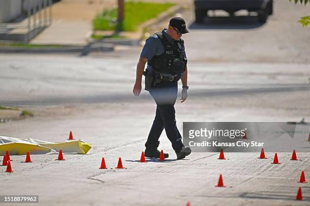 Evidence markers filled the street following a shooting near 57th Street and Prospect Avenue in Kansas City, Missouri, in June 2023.