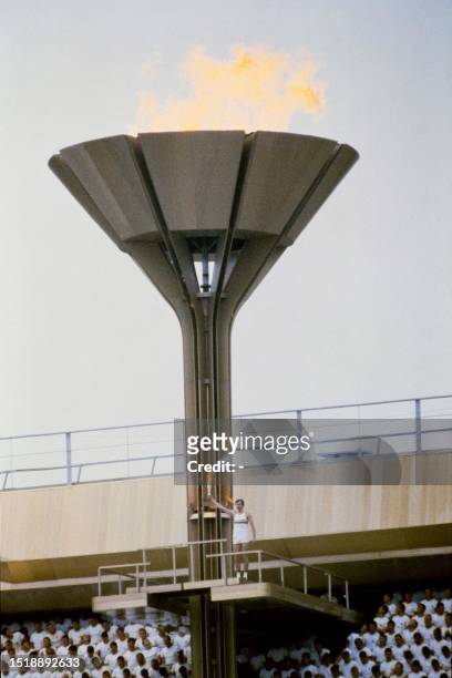 Soviet basketball player Sergei Belov lights the Olympic flame, at the Lenin Central Stadium during the opening ceremony, on July 19, 1980 in Moscow...