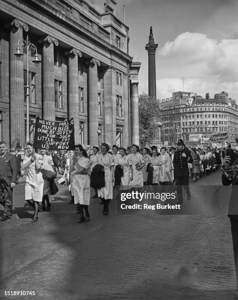 Crowd of people including nurses, march through central London in a Confederation of Health Service Employees protest march demanding higher wages,...