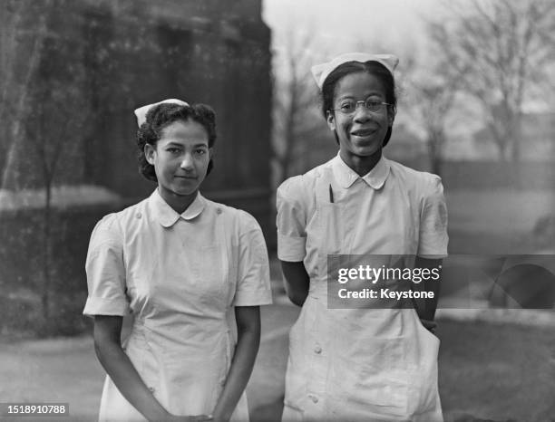 Nurse EL Gordan and Nurse M O'Loughlin, both from Saint Kitts Island, pose for a portrait, London, March 14th 1945.