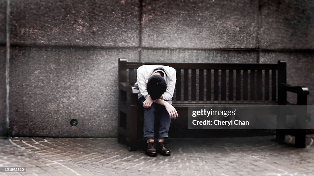 Depressed man sitting on bench