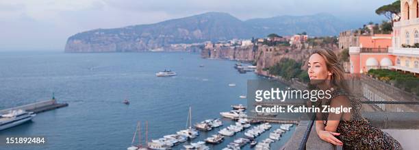 woman enjoying the view of sorrento bay, italy - sorrento italy stock pictures, royalty-free photos & images