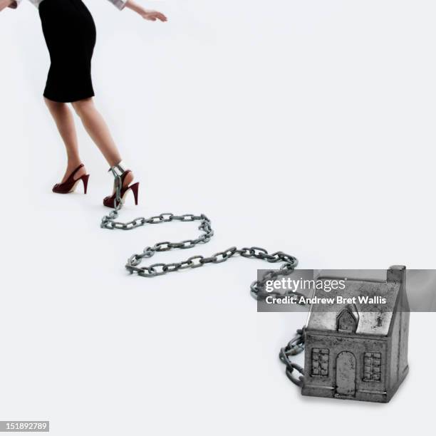 woman's ankle chained to a metal house - female foot models fotografías e imágenes de stock