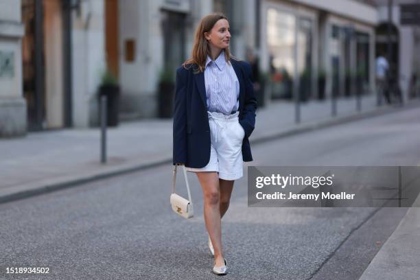 Marlene Fey wearing SoSue blue blazer, blue SoSue long blazer, light blue SoSue blouse and white short SoSue shorts, white small Celine bag, silver...