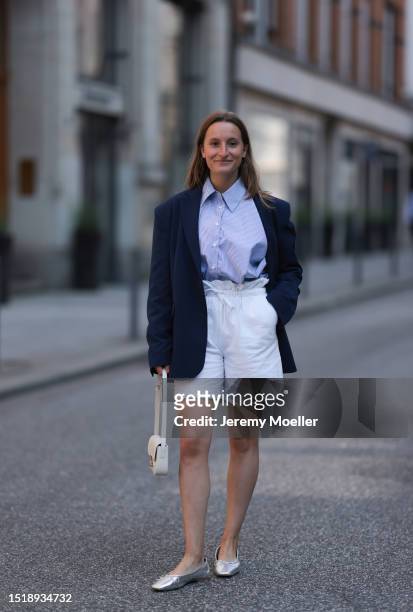 Marlene Fey wearing SoSue blue blazer, blue SoSue long blazer, light blue SoSue blouse and white short SoSue shorts, white small Celine bag, silver...