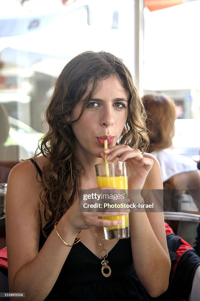 Woman enjoying a drink of  fresh juice