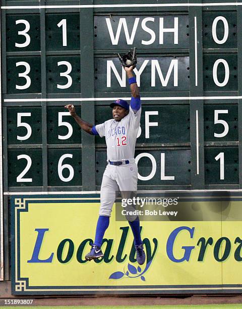 Alfonso Soriano of the Chicago Cubs makes a leaping catch at the wall on a ball hit by Matt Dominguez of the Houston Astros in the fifth inning at...