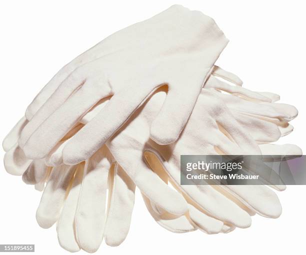 a stack of white cotton gloves - white glove fotografías e imágenes de stock