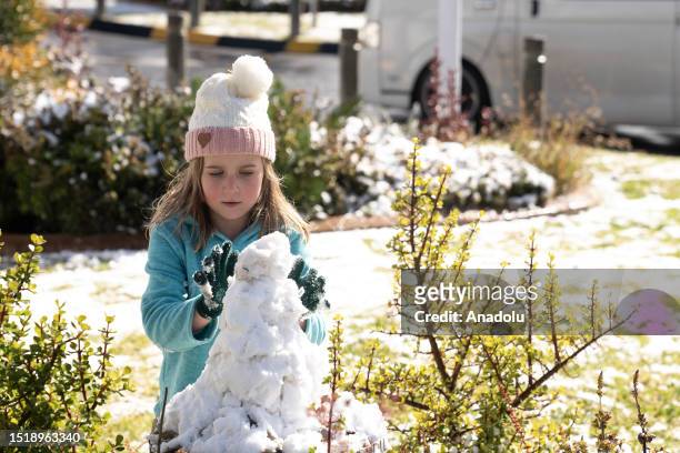 Child enjoys the snow after a snowfall in Johannesburg, South Africa on July 10, 2023.